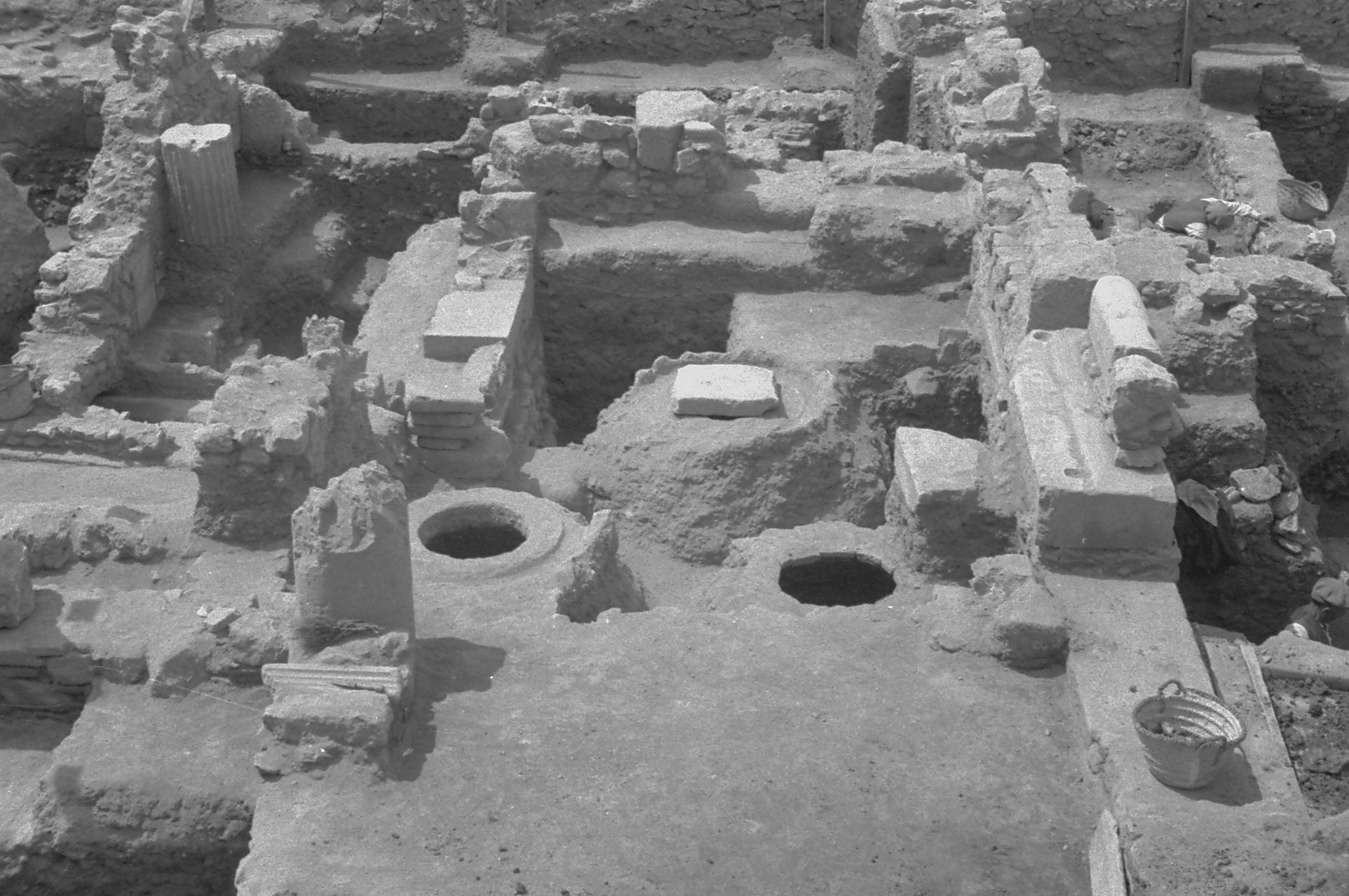 Interior of a Middle Byzantine house, with parts of the walls, threshold, and pithoi visible (Section MM). (Source: American School of Classical Studies at Athens: Agora Excavations)